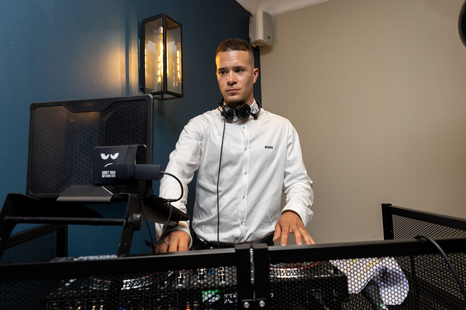 DJ RHUE close-up mixing a live Afrobeats and Dancehall set — club booth performance